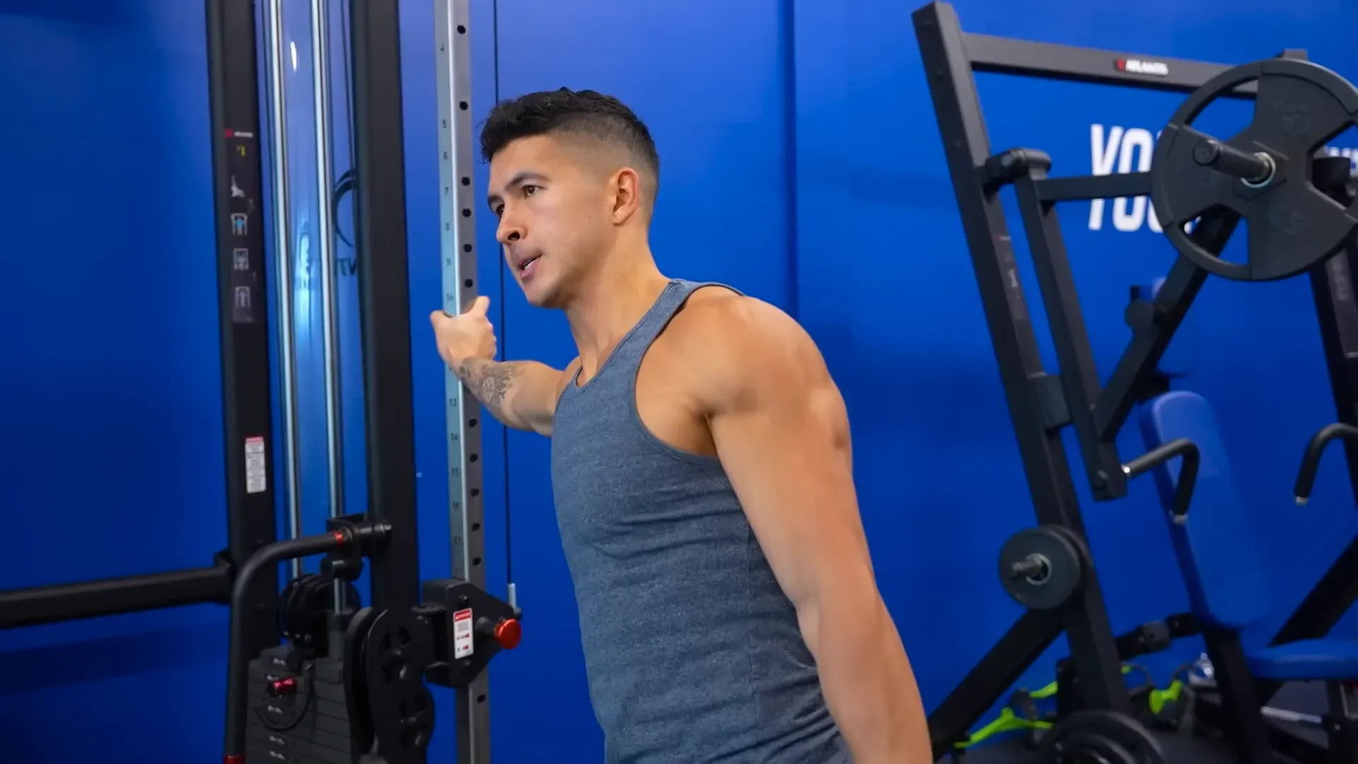 Demonstrating lean-in lateral raises